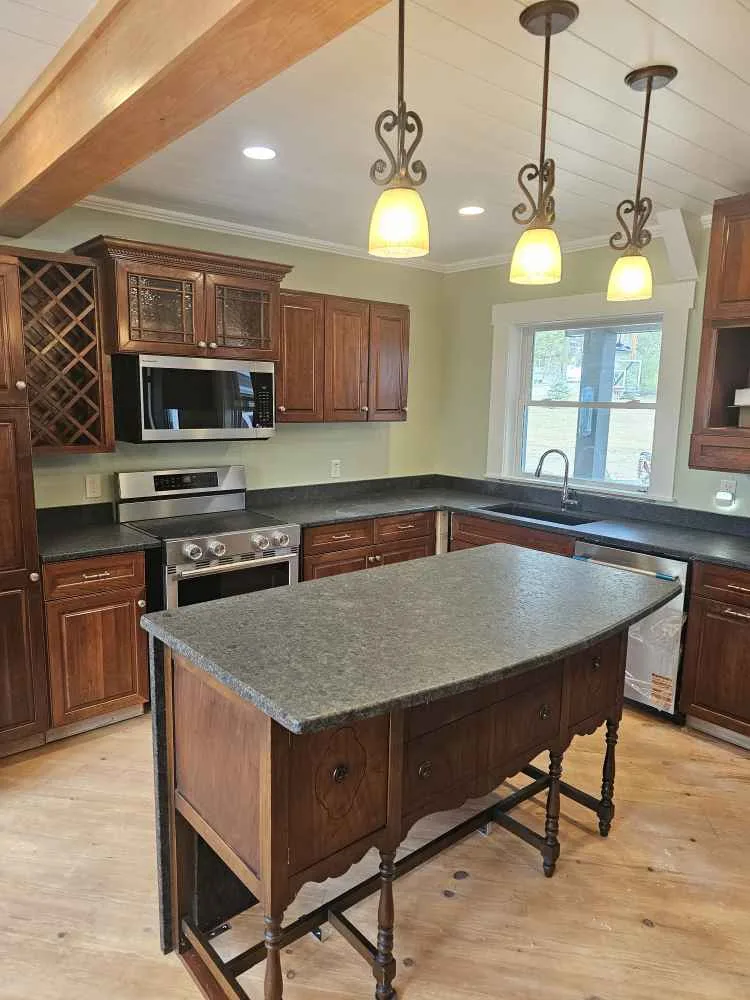 Coffee Brown leathered granite kitchen island in a Pittsfield, New Hampshire home.