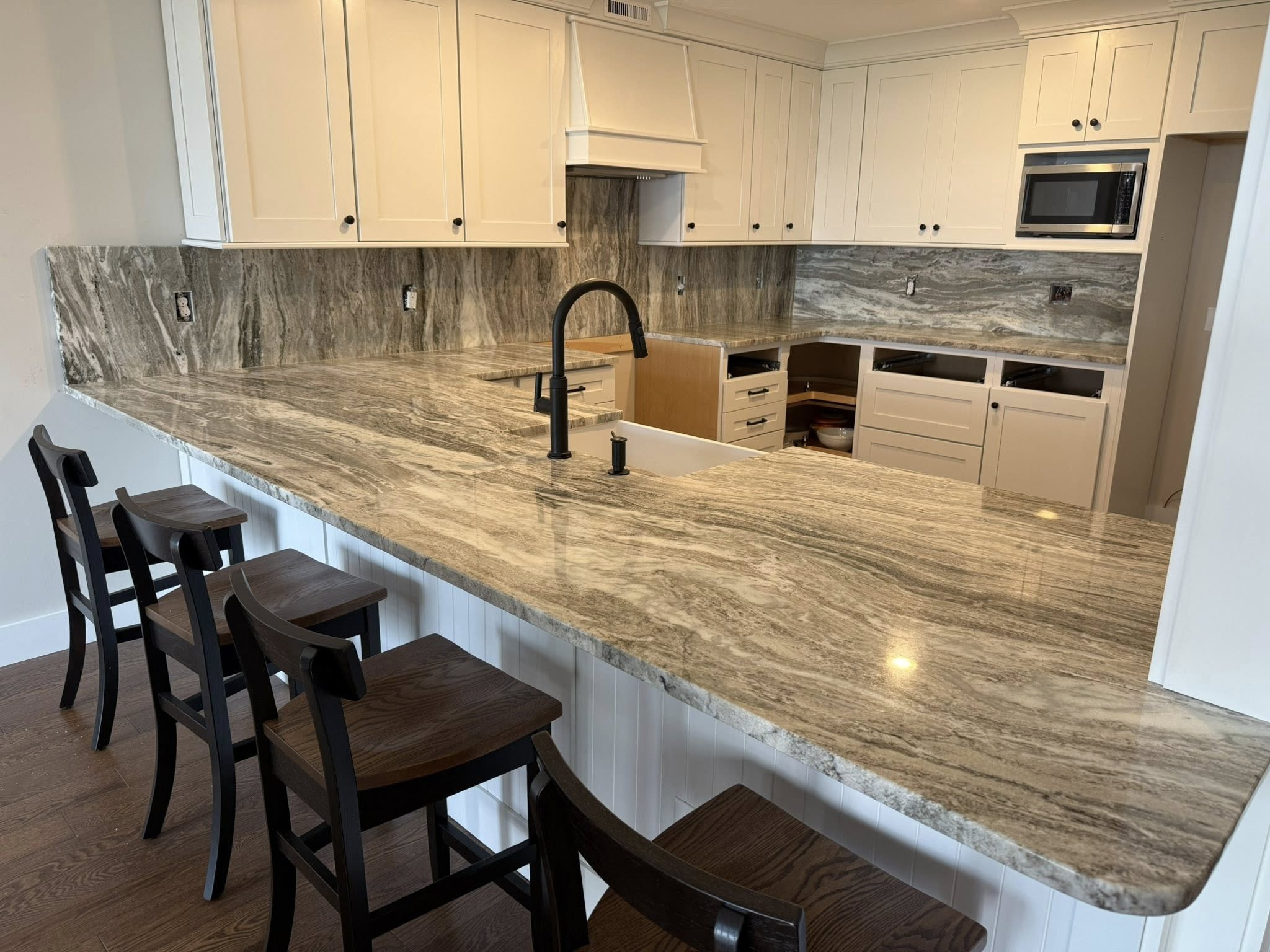 Fantasy Brown stone kitchen countertop with matching full-height backsplash showing continuous natural veining