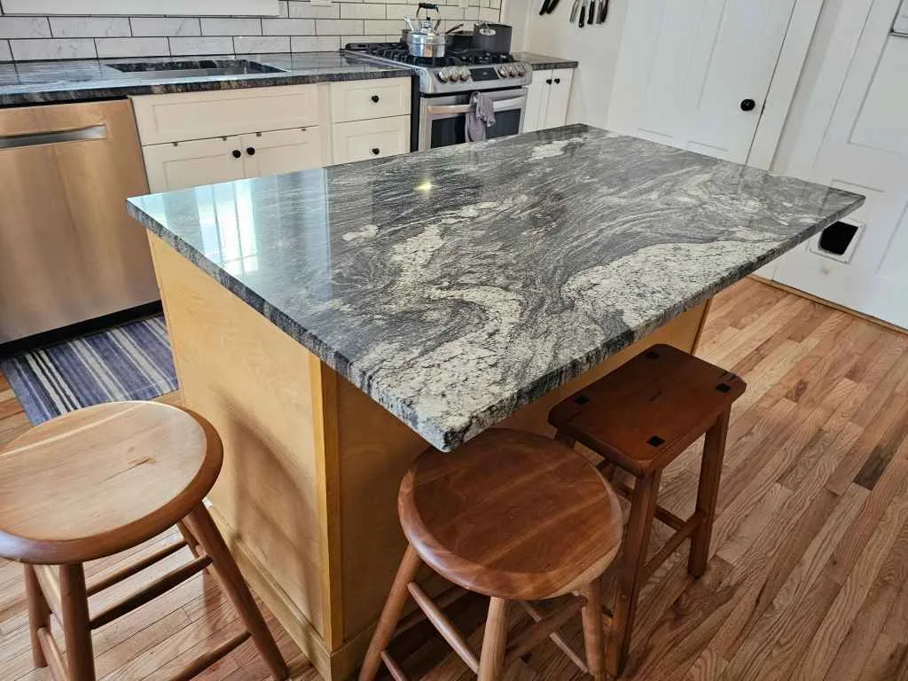 Kitchen island with a natural stone countertop in a Concord, NH home