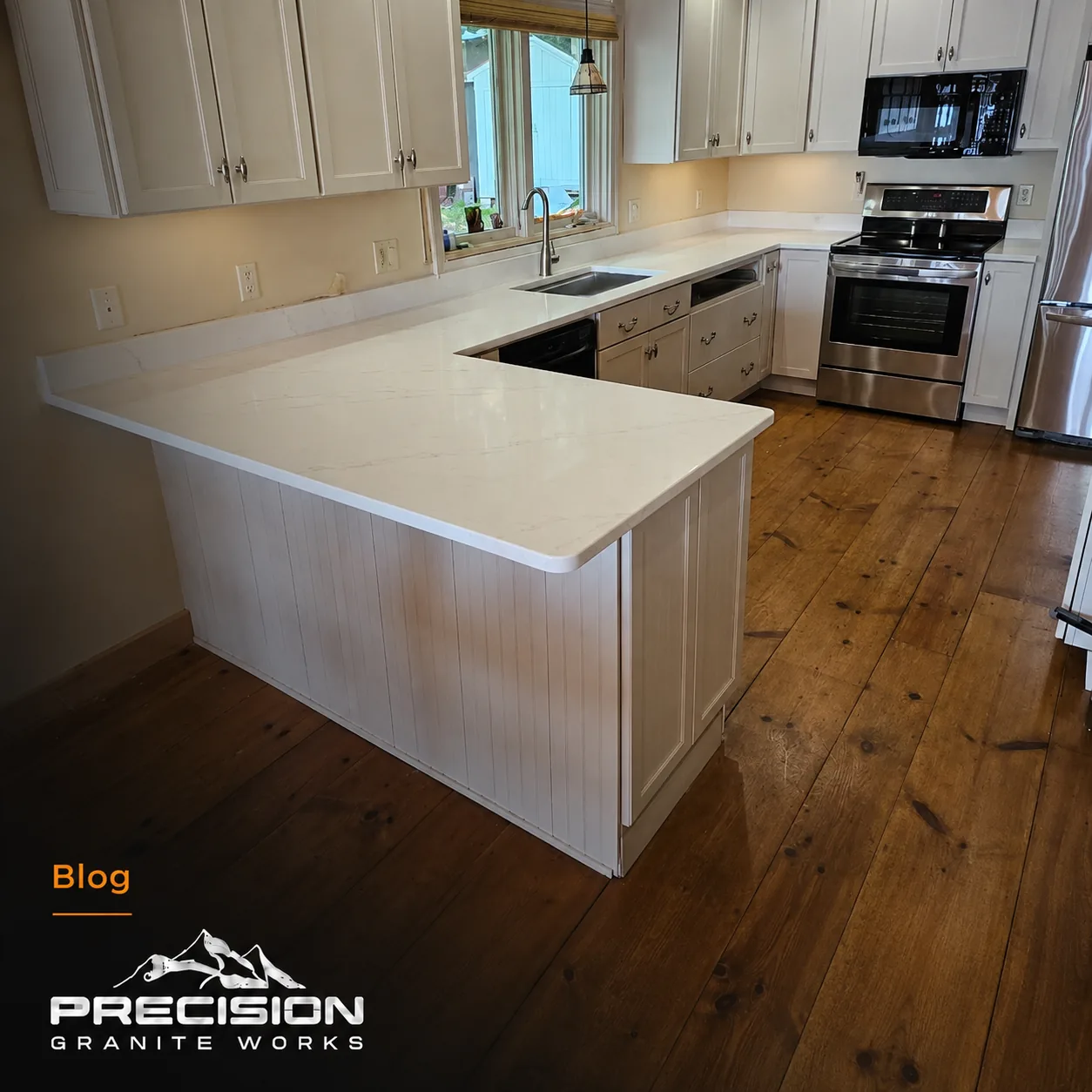 White countertop island with perimeter counters in a finished kitchen