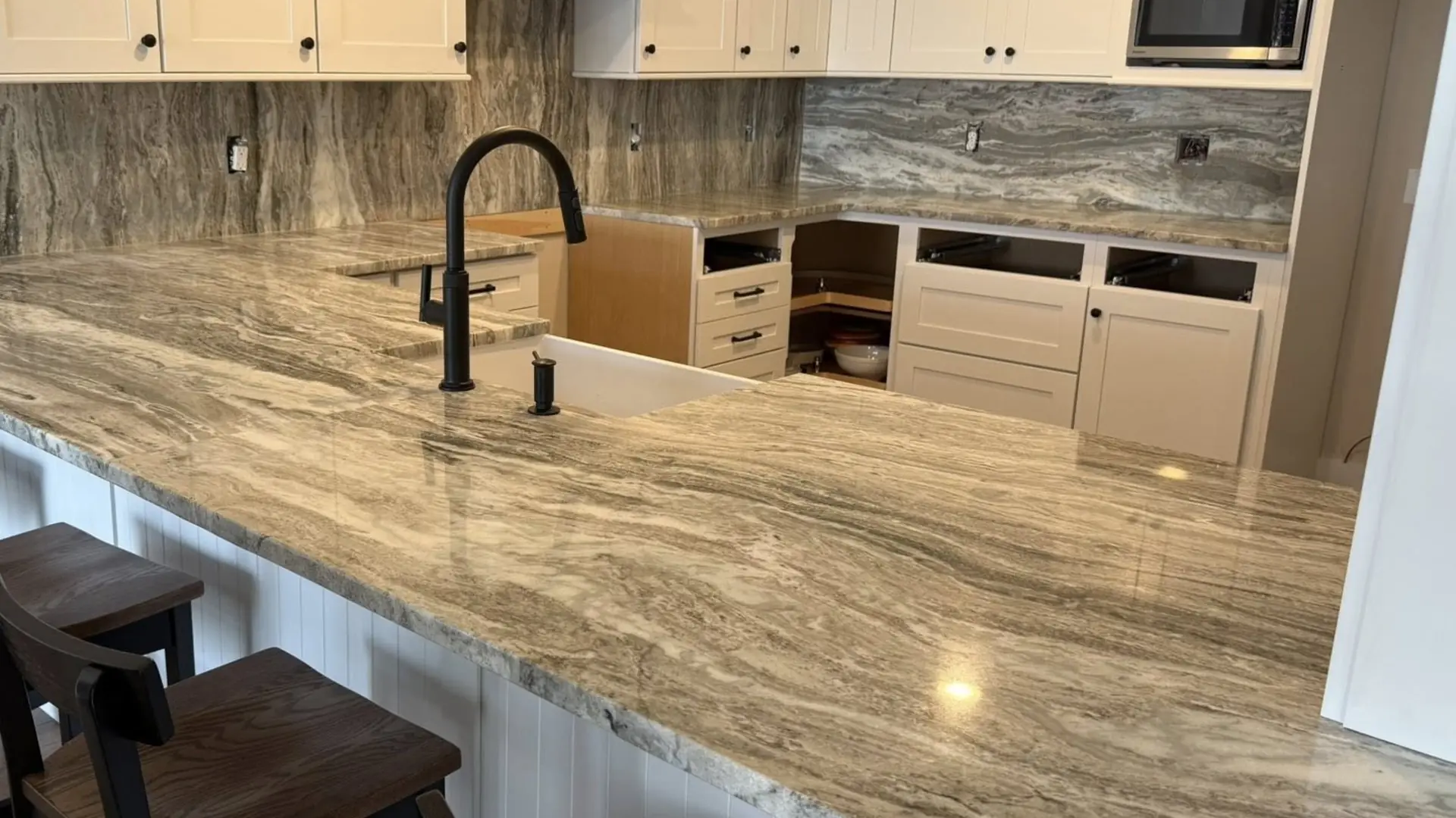 Granite peninsula kitchen countertop fabricated and installed by Precision Granite Works in a New Hampshire home