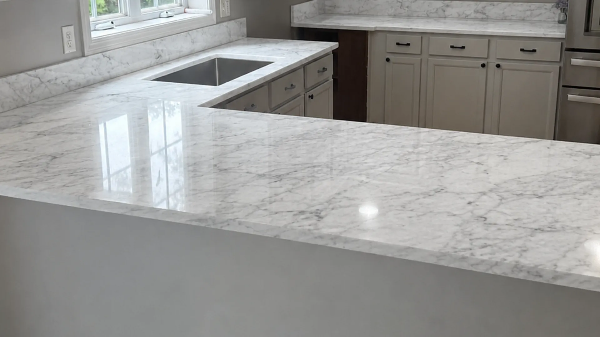 Elegant white marble countertops with soft grey veining in a New Hampshire home