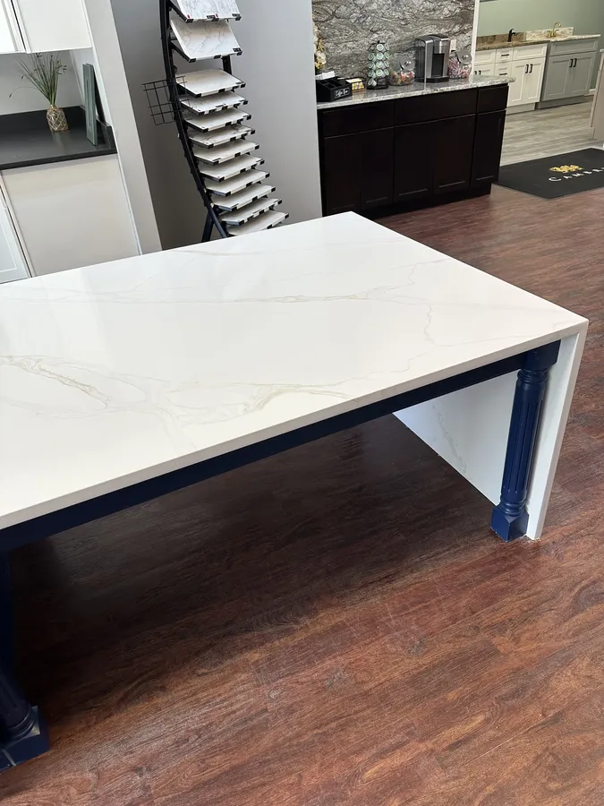 White quartz waterfall island display showing the seating overhang and open knee space