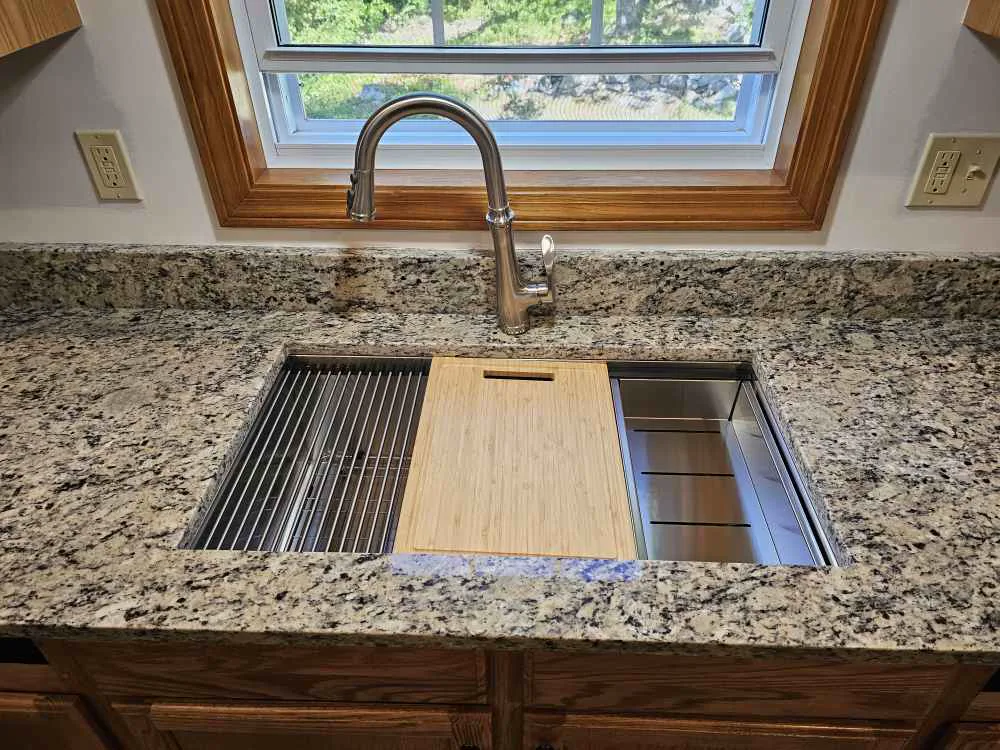 Workstation undermount sink with cutting board and draining rack installed in a granite countertop in Barnstead, NH
